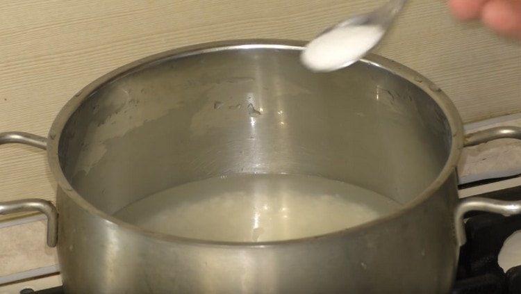 Salt the rice and cook until half ready.