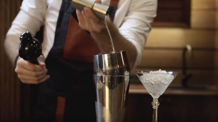 Add lime juice to the components already in the shaker.