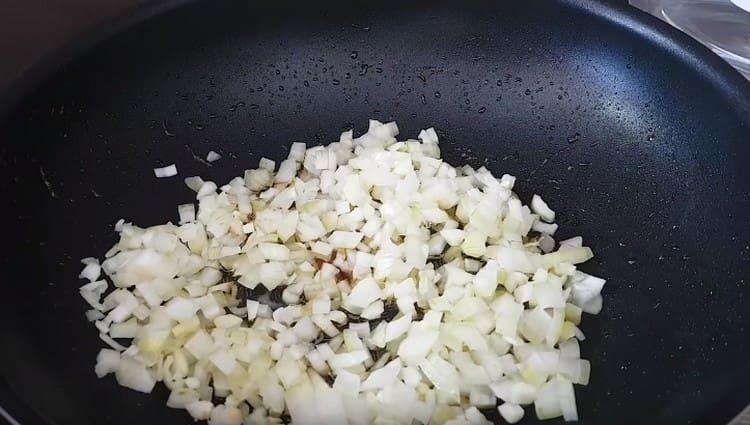Fry chopped onions in a pan.