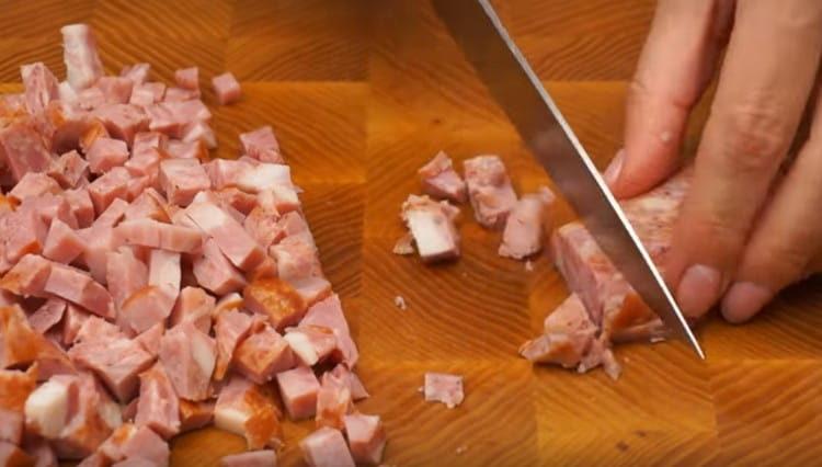 dice boiled eggs and sausage.