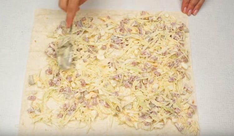 distribute the filling on a sheet of pita bread.