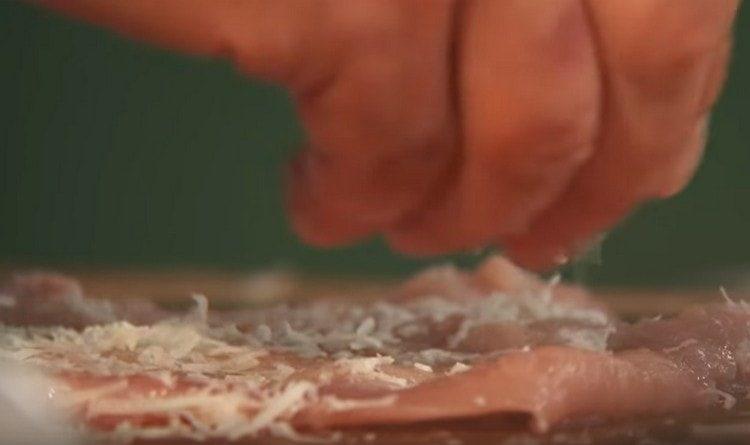 sprinkle the meat with grated parmesan and rub it.