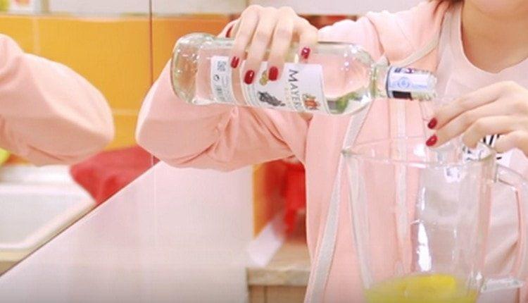 Add white rum to the blender.