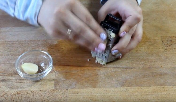 Three garlic on a fine grater.