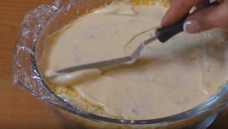 then spread the grated eggs, make a mayonnaise layer
