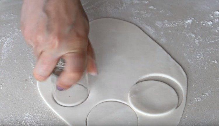 roll out white mastic and cut out circles.