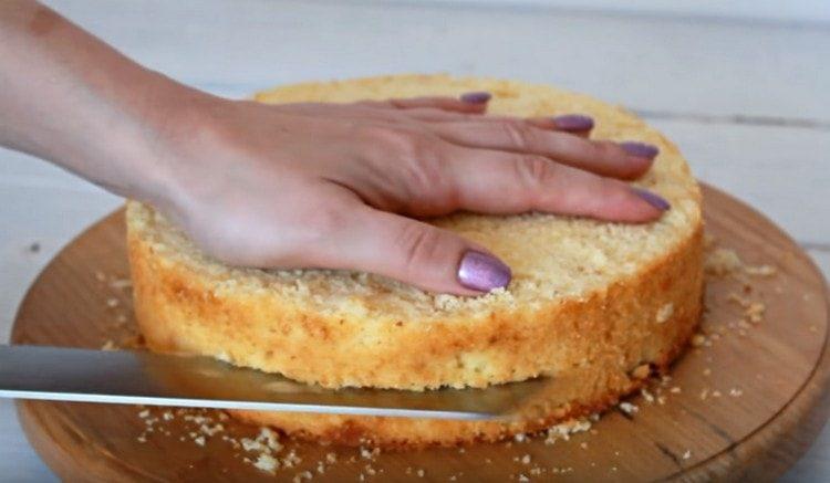 We cut the cakes in half, after carefully cutting the tops.