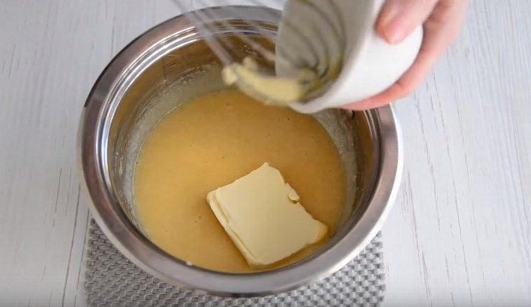 Add the butter to the mass and put it on the fire.