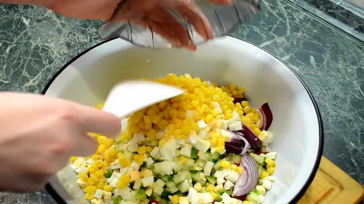 pour corn into salad