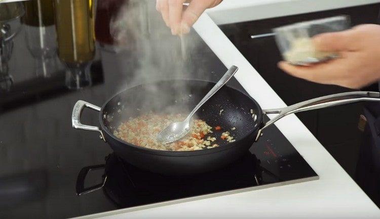 Salt and pepper the vegetables in the pan.