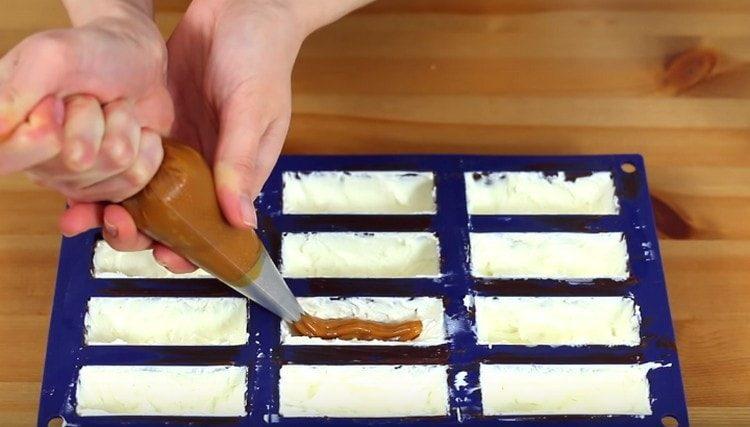 Squeeze condensed milk in each cell in the center.