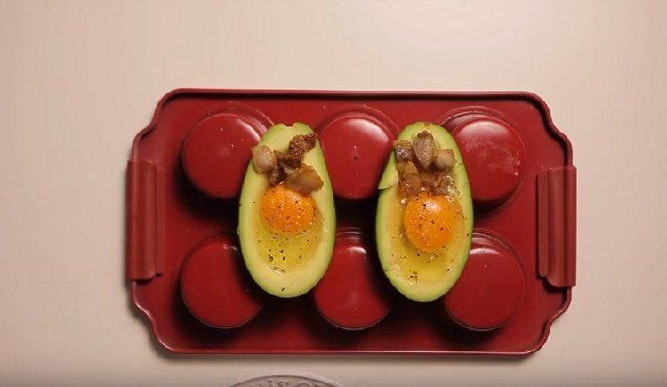 Add the bacon and send the avocado into the oven.