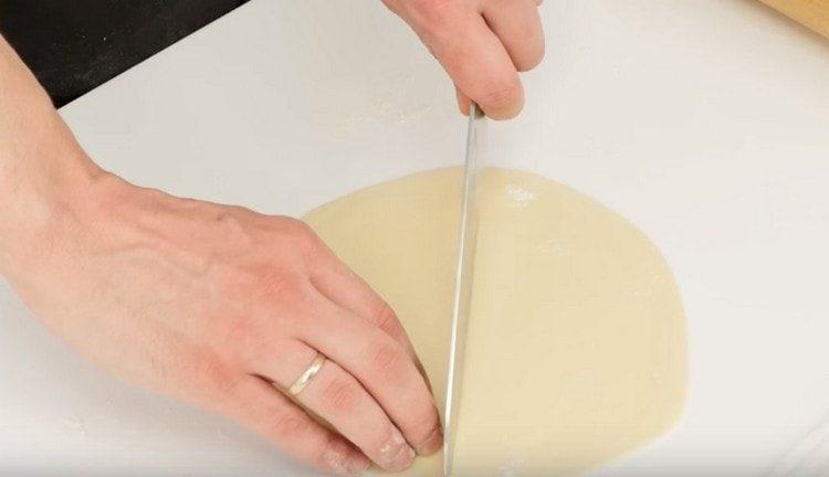 The resulting thin cake is cut in half.