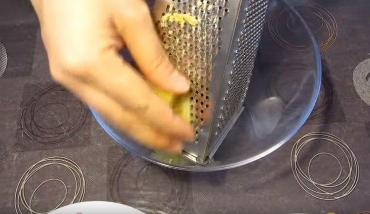 Three boiled potatoes on a fine grater.