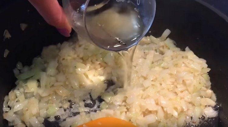 Add white wine to the onion with garlic.
