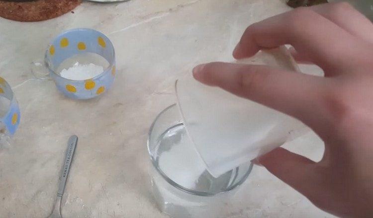 First add sugar to the water and mix.