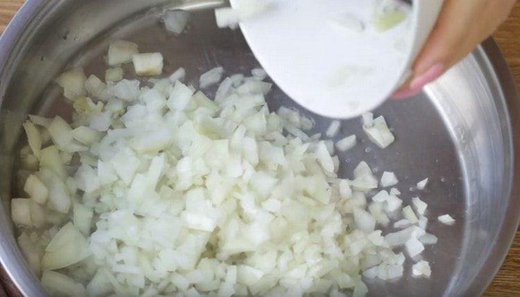 Fry chopped onions in a pan.