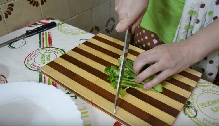 Dice red and green bell peppers.