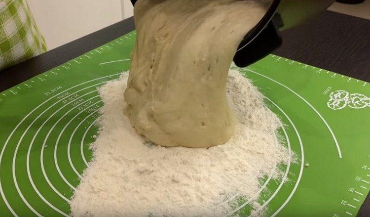 We shift the dough into a dusted surface.