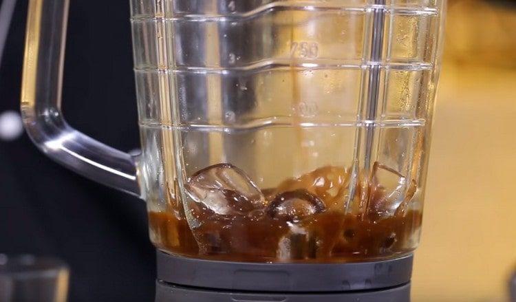 Pour pre-brewed coffee into a blender glass. add ice cubes and sugar