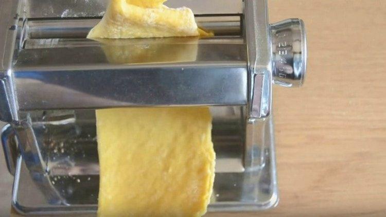 Using a special machine, we roll out the dough more finely.