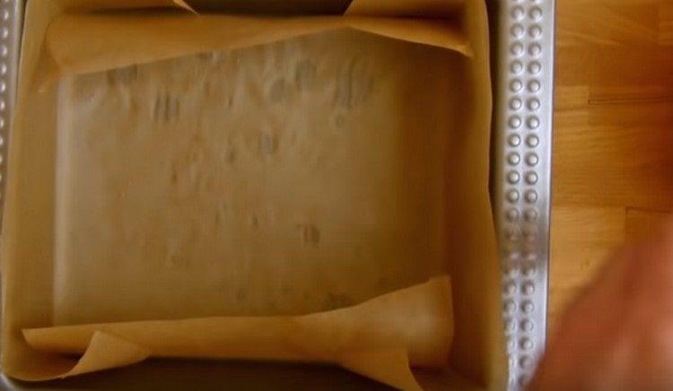 We cover the baking dish with parchment.