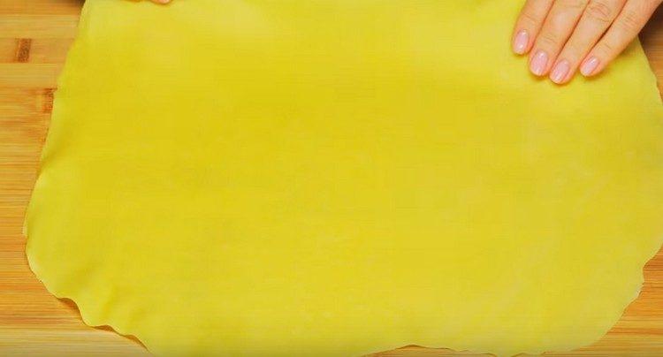 Divide the dough in half and roll it thinly.